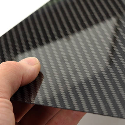 Carbon Fibre Sheet in Hand with Reflections