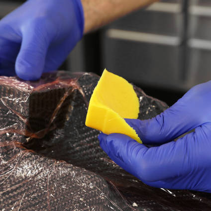 Placing cured silicone intensifier in the corner of a mould