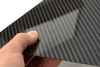 High Strength Carbon Fibre Sheet in Hand with Reflection Thumbnail